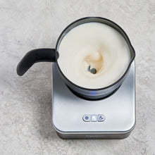 Capresso Automatic Milk Frother pitcher with creamy froth and soft blue interior light