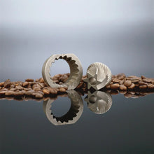 Metal conical burr grinding plates with coffee beans