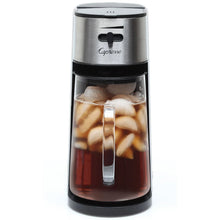 Capresso iced tea maker with handle and lid, glass carafe filled with ice tea