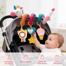 Baby in stroller with hanging plush unicorn, cupcake/ice cream, and star rattle toys