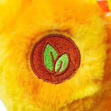 14 in plush bear close-up with orange fur and brown round emblem with green leaf