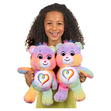 Two Togetherness Bear plushes with rainbow heart bellies and smiling faces.