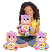Three Togetherness Bear plushes with rainbow heart bellies and heart paw pads.