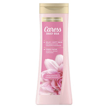 Caress Daily Silk moisturizing body soap bottle, pink with gold cap.