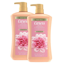 Pair of daily silk body wash bottles with gold pumps, peach liquid, floral labels