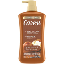 Brown body wash bottle with gold pump and Caress exfoliating label