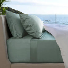 Teal bed sheet set with matching pillowcases on sofa bed
