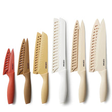 Kitchen knife set with multiple blades, cream, taupe, red, and brown nonstick coating.