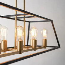 Long pendant light with slanted black metal frame, multiple clear bulbs, brass details