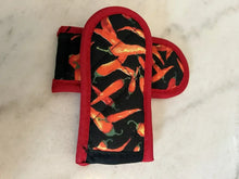 Skillet handle cover with black chili pepper pattern and red trim, single sleeve