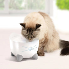 Catit Pixi cat drinking fountain, white cat-shaped base as a cat drinks