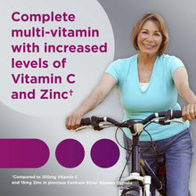 Senior woman riding a bicycle wearing a light blue T-shirt and helmet