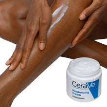 Moisturizing cream jar beside hands applying white cream to skin