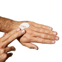 Moisturizing cream applied to forearms with a small white dollop