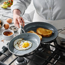 Ceramic nonstick skillet pair frying eggs and toasting bread on gas stove