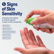 Moisturizer being squeezed onto palm, green tube held over hand with sensitivity icons
