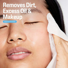 Facial cleansing wipe held to cheek for gentle, fragrance-free cleansing