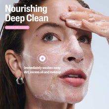 Facial cleanser foam being spread on face, hands applying cleanser to skin