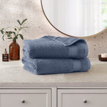 Blue bath towel set, two folded plush towels with matching ribbed border