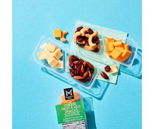 Assorted snack trays with cheese cubes, nuts, and dried fruit plus snack pack