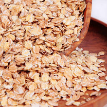 Oat flakes piled in a wooden bowl