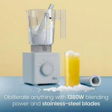Ice-crushing blender with ice inside jar and a filled glass beside it