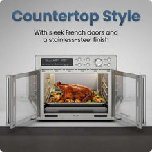 Chefman stainless steel French door air fryer toaster oven on countertop with oven cavity open