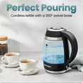Electric kettle on 360° swivel base with cups and tea, black kettle.