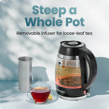 Black and stainless electric kettle with removable infuser and cup of tea
