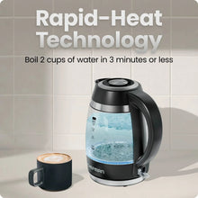 Black electric kettle with glass-style water window and handle, standing on base