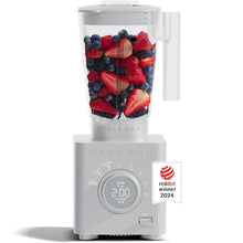 White blender base with clear jar filled with ice and berries