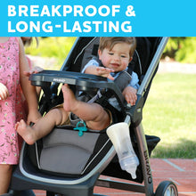 Baby bottle clipped in stroller cup holder for on-the-go feeding