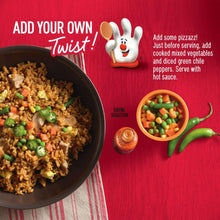 Chicken fried rice in a dark bowl with green peas and diced vegetables