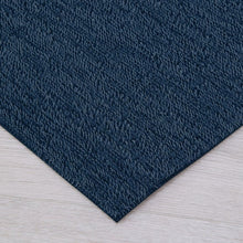 Navy shag indoor/outdoor mat corner with looped texture and angled edge