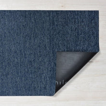 Navy shag indoor/outdoor mat corner showing fabric and backing edge