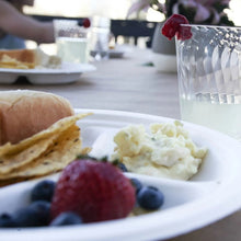 White compartment paper plate with three sections on a table setting