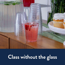 Clear crystal plastic cups on a table, one filled with red drink
