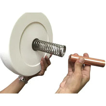Anode spring and copper rod for pool skimmer, shown with hands
