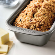Grey nonstick bread loaf pan filled with golden crumb bread slices