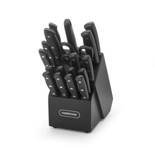 Black cutlery block holding assorted stainless knives and kitchen shears