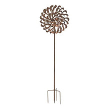 Metal pinwheel wind spinner with brown pinwheel blades and stake prongs, isolated view.