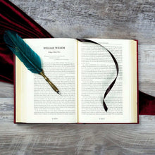 Hardcover horror book, open pages with serif text and ribbon bookmark