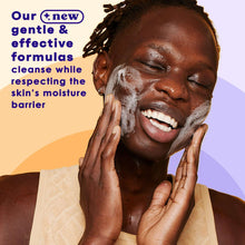 Acne face wash with cleansing foam on face, hands pressing cheeks