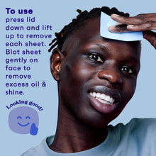 Oil absorbing sheet held to face to blot excess oil and shine