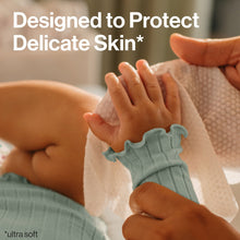 Ultra-soft quilted wipe held by hands while cleaning a baby