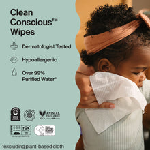 Baby cuddling a white wipe during gentle skin cleaning