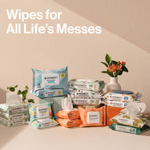 Assorted Honest wipes packs stacked with white wipe sheets