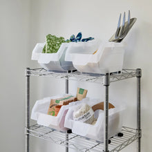 White stacking storage bins on a metal rack, with compartments holding utensils and small items.