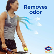 Person using stain remover on fabric to remove odor, shown with spray bottle.