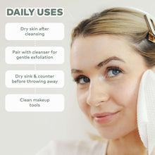 White eco cleansing towel wipe, held to face for post-cleanse drying